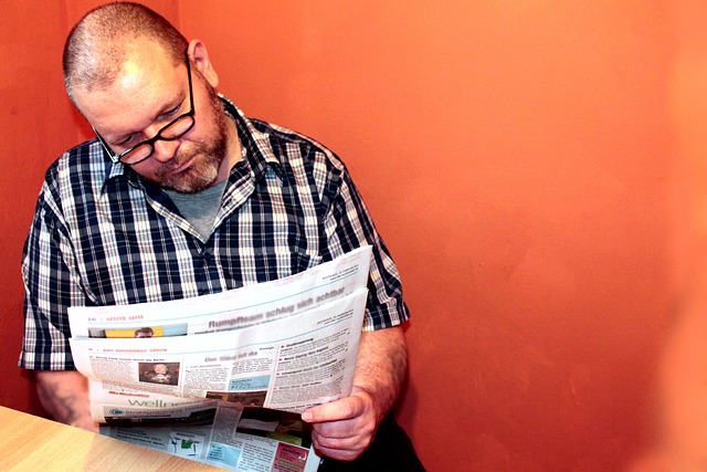 London financial district newspapers and tablet reading