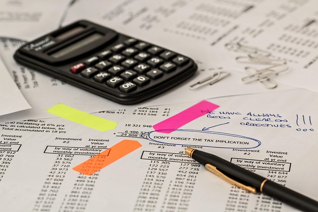 investment program documents and calculator on desk UK