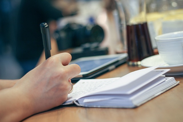 person reviewing terms and financial documents at desk